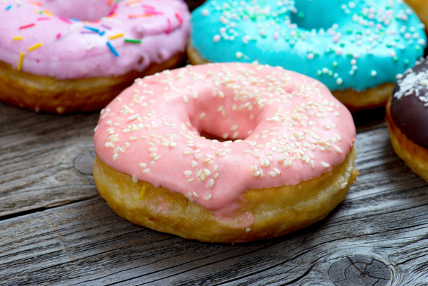 Donuts on a wooden background - Foto, afbeelding