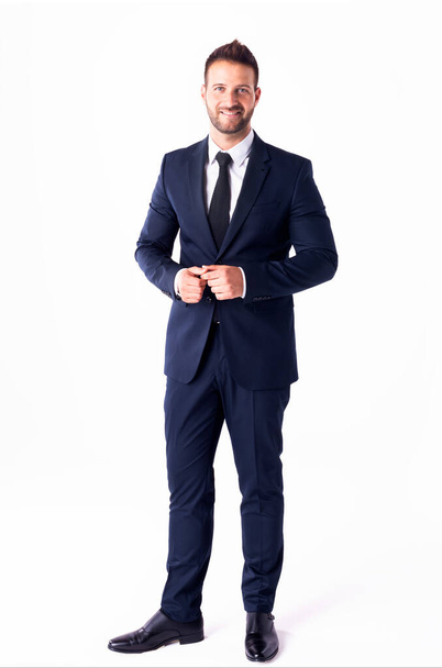 Full length shot of handsome businessman wearing suit while standing at isolated white background. - Fotoğraf, Görsel