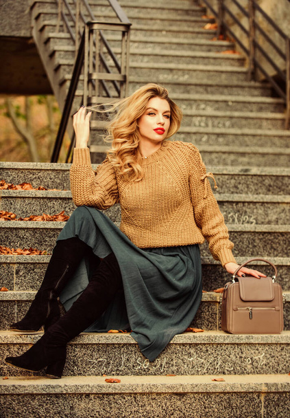 Taking some time to rest. casual style student. fall season. girl long blond hair stairs. girl in skirt and sweater. Pleated trend. female beauty. Fashion model. autumn woman curly hair outdoor - Foto, Bild