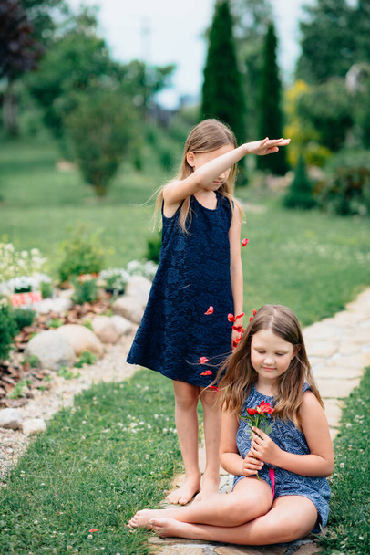 two happy girls in  park with flowers - Zdjęcie, obraz