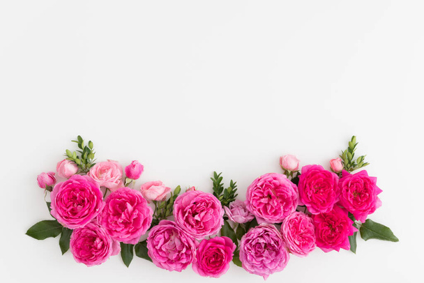 Pink roses on a white table. Flat lay with blank copy space. - Photo, Image