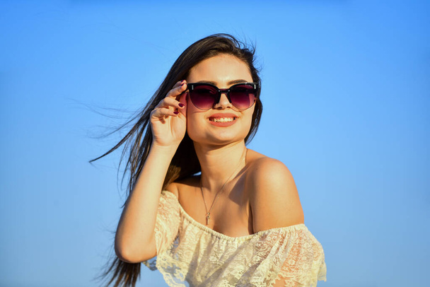 Girl in sunglasses copy space. Freedom. Carve out time for yourself. Harmony and balance. Female psychology. Beautiful woman on sunny day blue sky. Female power. Summer fashion. Find inner strength - Valokuva, kuva