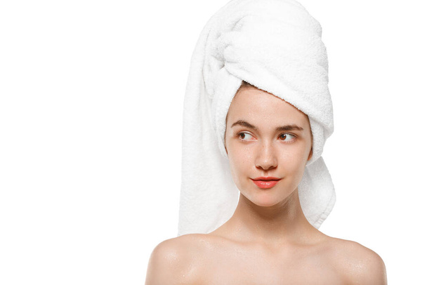 Beauty Day. Woman wearing towel doing her daily skincare routine isolated on white studio background - Valokuva, kuva