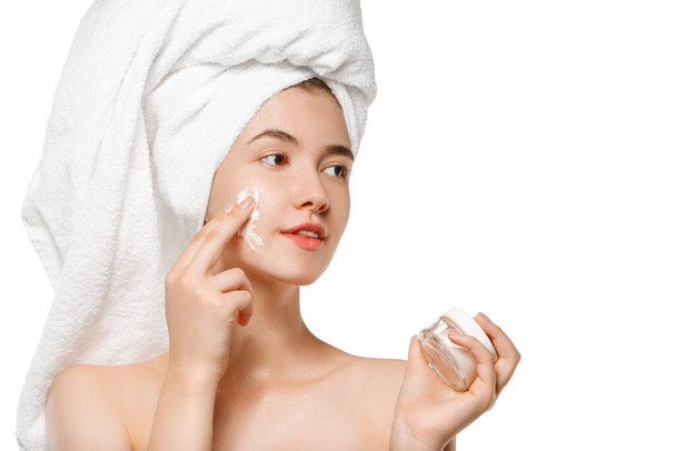 Beauty Day. Woman wearing towel doing her daily skincare routine isolated on white studio background - Фото, зображення