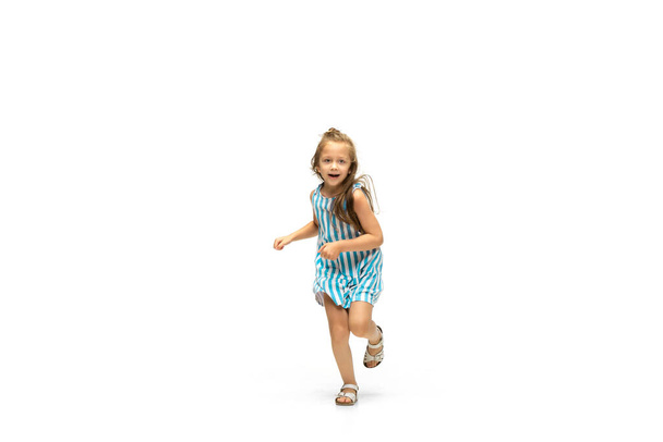 Happy little caucasian girl jumping and running isolated on white background - Fotografie, Obrázek
