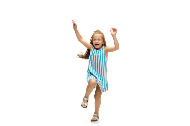 Happy little caucasian girl jumping and running isolated on white background - Foto, immagini
