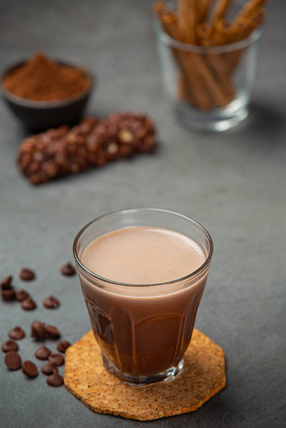 Cocoa served with a delicious chocolate dessert on a black background.. - Zdjęcie, obraz