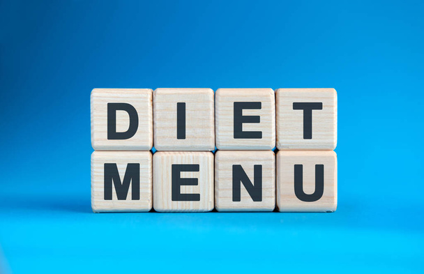 DIET MENU - text on wooden cubes on a blue gradient background - Foto, immagini