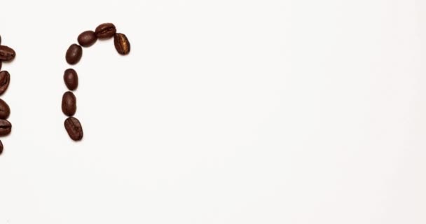 Stop motion animation close up view of word Coffee made of coffee beans on white background isolated. - Metraje, vídeo