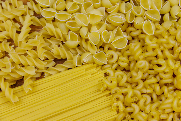 Variety of types and shapes of raw italian pasta. Close-up - Φωτογραφία, εικόνα