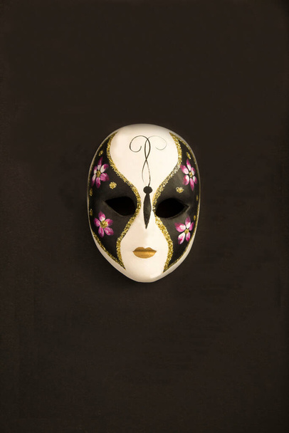 Venetian carnival mask in the center of the black background. Top view. Copy space. Location vertical. - Photo, Image