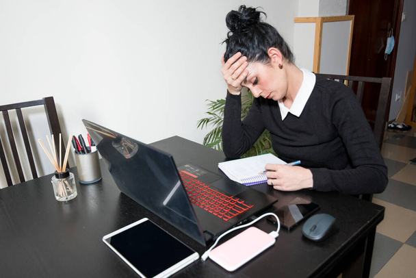young girl stressed out while working at home with a laptop and tablet. - Photo, Image