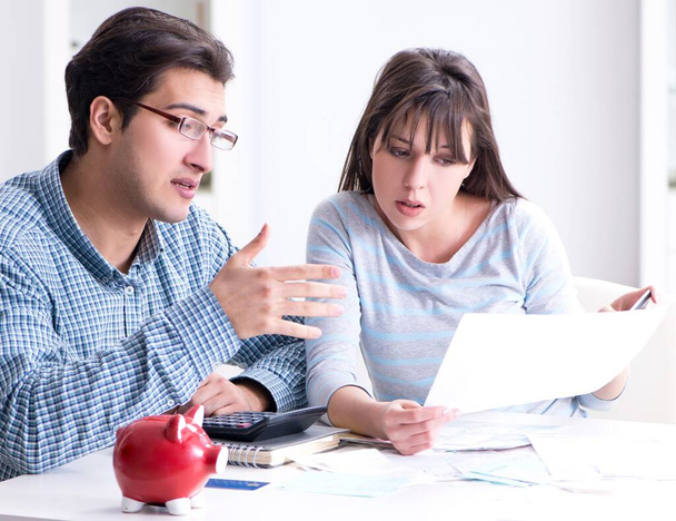Junges Paar schaut auf Familienfinanzierungspapiere - Foto, Bild