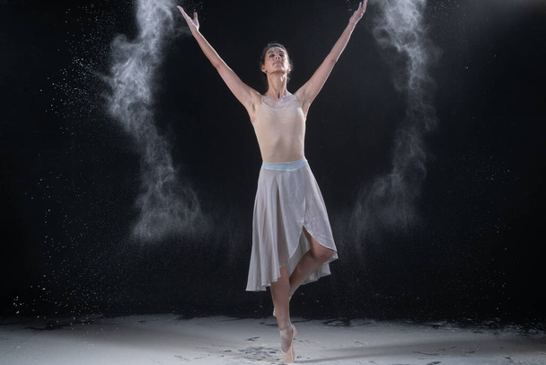 ballerina dancing in studio with white flour - Photo, Image