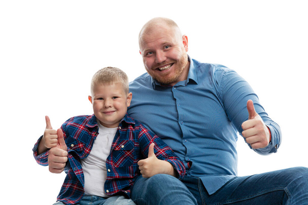 Dad and little son are smiling and hugging. Love and tenderness in a relationship. Isolated on white background. - Фото, зображення
