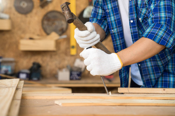 The carpenter is using a hammer to chisel To trim wood - Photo, Image