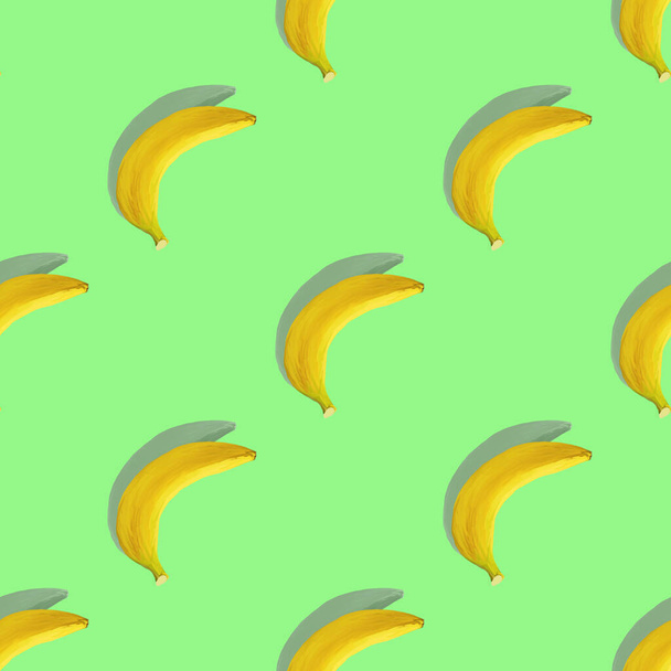 Banana with shadow on a mint background. Seamless pattern. Color, diet. Tropical pattern with bananas. - Фото, изображение