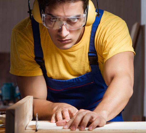 Pracovník pracující v opravárenské dílně v dřevoobráběcím konceptu - Fotografie, Obrázek