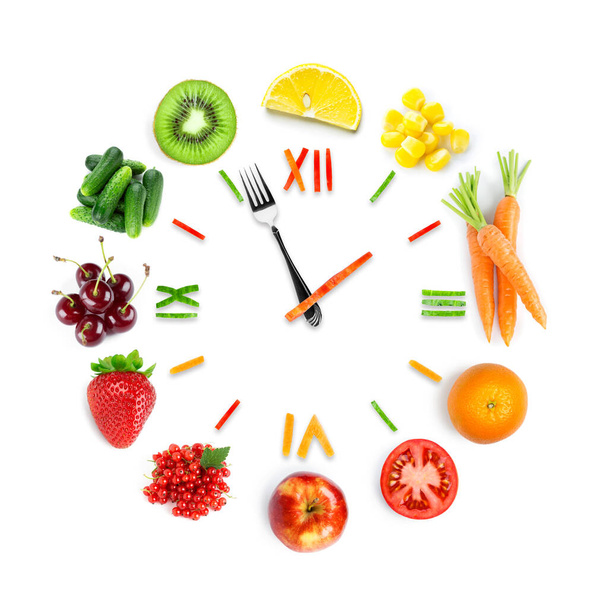 Food clock with fresh fruits and vegetables. Healthy food - Foto, Imagem