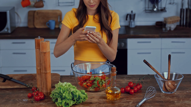 cropped view of happy woman taking photo of fresh salad in bowl  - Footage, Video