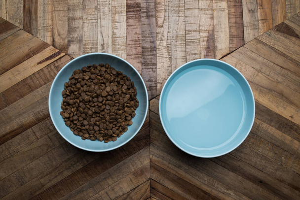 cat food dishes with dried food and water - Fotó, kép