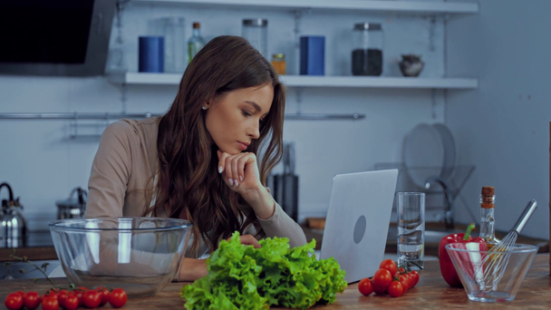 attractive woman using laptop near ingredients on table  - Filmagem, Vídeo