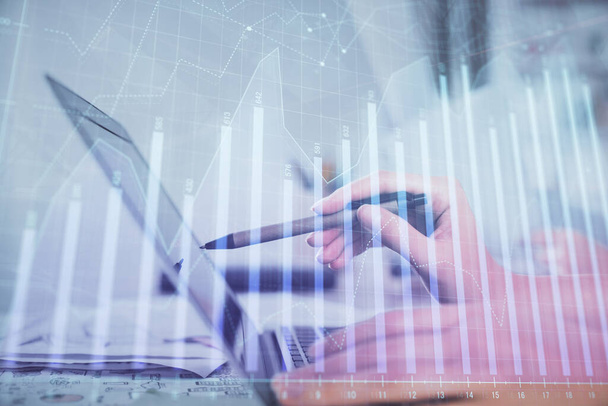 Multi exposure of woman hands typing on computer and financial graph hologram drawing. Stock market analysis concept. - 写真・画像