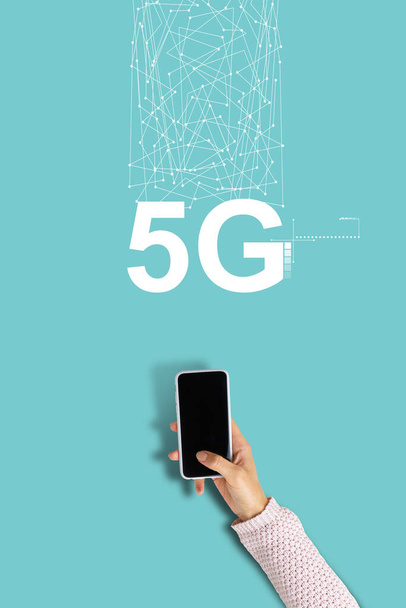 5G network inscription with hand holding smartphone. - Photo, Image