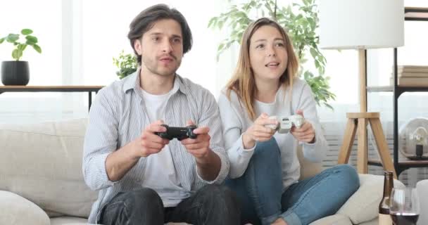 Crazy couple playing video game at home - Video