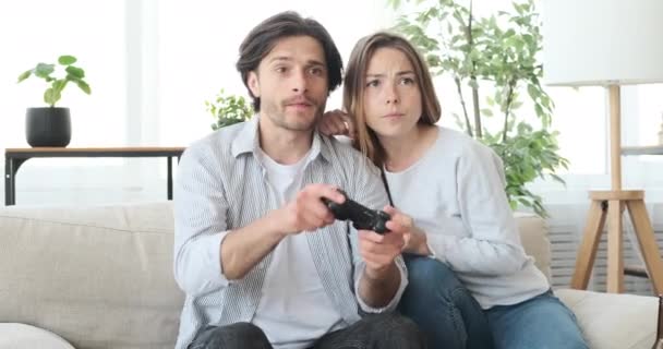 Crazy couple playing video game at home - Footage, Video