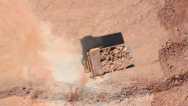 Cinematic aerial top down view of a dumper truck unloading in the quarry, USA - Footage, Video