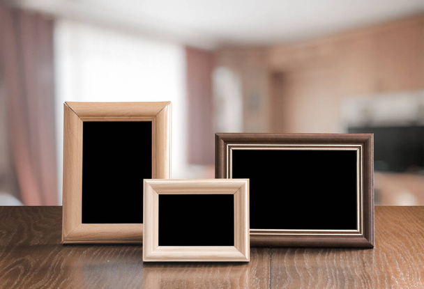 photo frames on the wooden table in the living room - Photo, Image