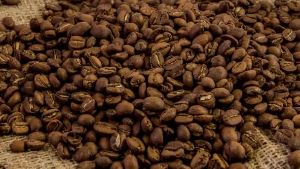 Close-up zoom out rotating of roasted coffee beans. Smooth motion of arabica coffe seeds. - Filmagem, Vídeo