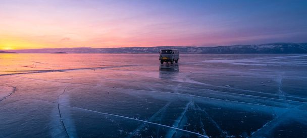 Beautiful sunset over Baikal frozen lake in winter season,  Olkhon island, Siberia,Russia, Asia. Panoramic banner portion - Photo, image
