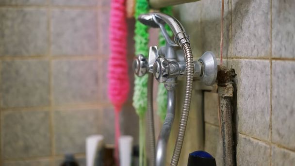 colourful sponges and washcloths hang on wall behind shower - Photo, Image