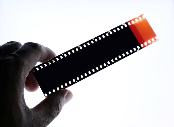 Color negative film 35mm, Photographic film top view in darkroom. - Фото, зображення