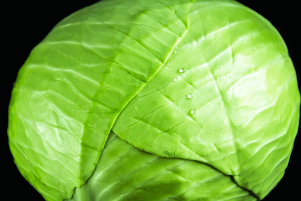 Green cabbage isolated on black background. Close-up view - Φωτογραφία, εικόνα
