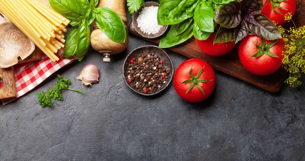 Italian cuisine ingredients. Garden tomatoes, pasta, herbs and spices. Top view with copy space. Flat lay - Photo, Image