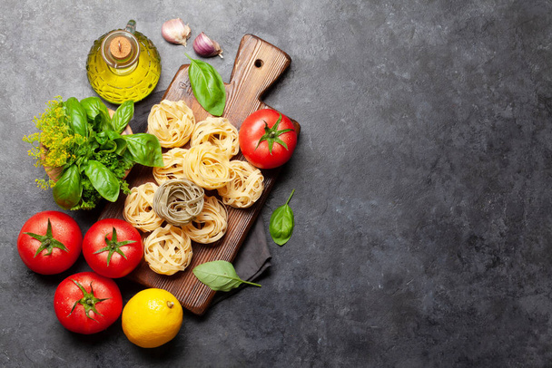 Italian cuisine ingredients. Garden tomatoes, pasta, herbs and spices. Top view with copy space. Flat lay - Fotoğraf, Görsel
