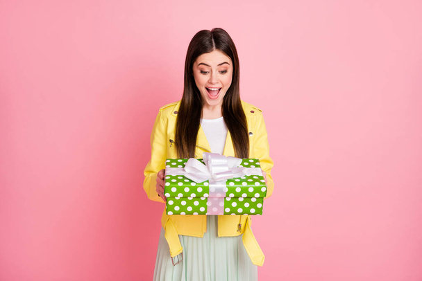 Portrait of her she nice-looking attractive pretty lovely glad cheerful cheery girl holding in hands romantic gift isolated on bright vivid shine vibrant yellow color background - Foto, immagini