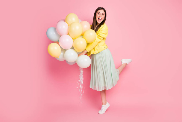 Full length body size view of her she nice-looking attractive lovely glad cheerful cheery girl holding in hands air balls chill out rest isolated on bright vivid shine vibrant yellow color background - Zdjęcie, obraz