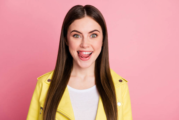 Closeup photo of funky crazy lady long perfect hairdo licking lips white teeth desire tasty dinner hunger eyes wear trend yellow leather jacket isolated pastel pink color background - Fotografie, Obrázek