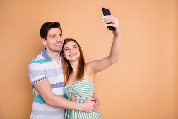Portrait of his he her she nice attractive lovely charming tender cheerful cheery couple friends friendship taking making selfie embracing isolated over beige pastel color background - Fotografie, Obrázek