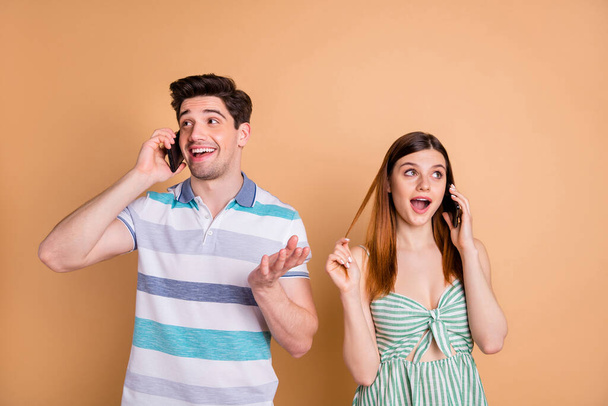 Portrait of his he her she nice attractive pretty cheerful cheery couple using cellular roaming service calling home abroad talking isolated over beige pastel color background - Foto, immagini