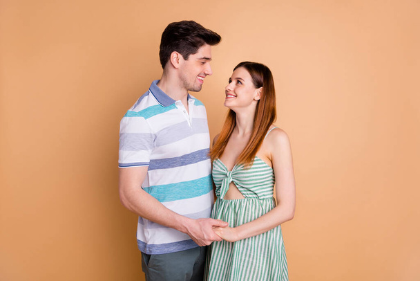 Portrait of his he her she nice attractive lovely charming affectionate careful cute tender gentle dreamy cheerful cheery couple holding hands isolated over beige pastel color background - Photo, Image