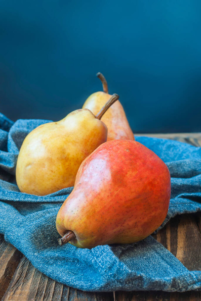 Delicious washed pears on a blue fabric. Selective focus. - Photo, Image