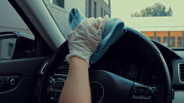 partial view of woman disinfecting steering wheel with sanitizer - Metraje, vídeo