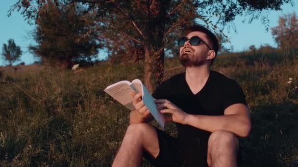 Spiritual happiness. Reading a book in the middle of nature. Spiritual relaxation. Leisure concept reading personal development carts - Imágenes, Vídeo