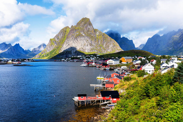 Reine, Lofoten, Norway. The village of Reine under a sunny, blue sky, with the typical rorbu houses. - Photo, Image