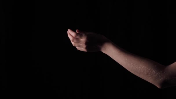 Female sensitive hand of musician pianist on black isolated background close up with artificial professional lighting - Footage, Video